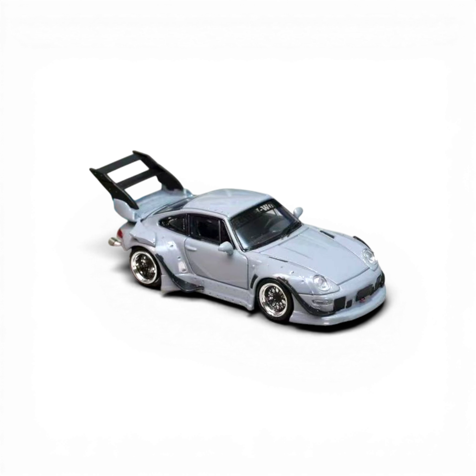 Lot57Supplies Diecast Shop 1:64 scale cement grey Porsche RWB 993 diecast model with a high tail spoiler.