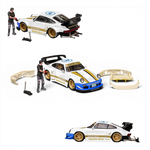 Lot57Supplies Diecast Shop 1:64 white Porsche RWB 930 model car with gold wheels, blue accents, and NFS livery. Includes figure and base.