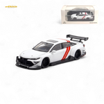 White and red model car with a black spoiler on a white background, featuring a Lotus logo.