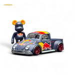 Toy figure of a bear with a Red Bull-themed toy truck on a white background