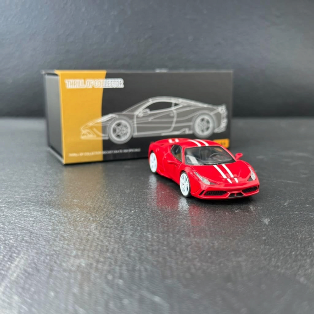 TOC x EDM x AHandofGod Ferrari 458 Rosso Corsa + White Stripe 1:64 diecast front three-quarter view with box behind